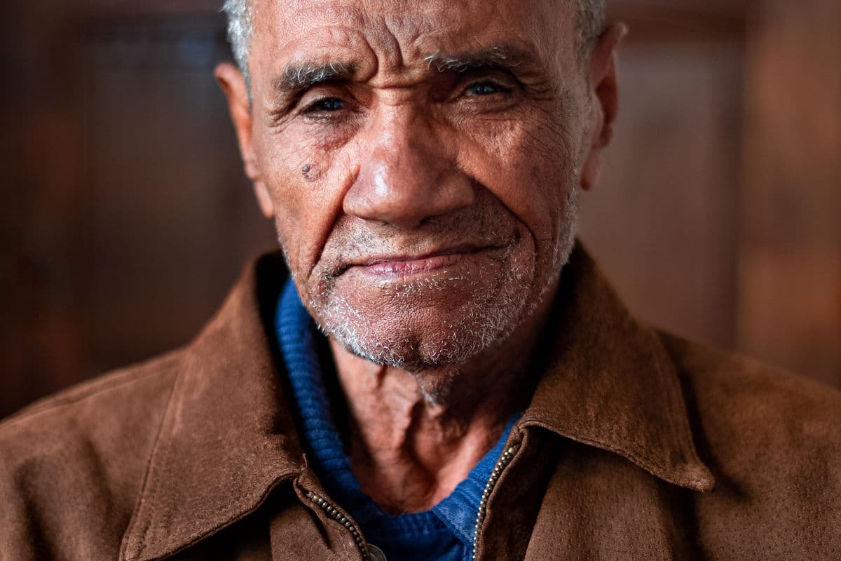 A portrait of an older man looking at the camera.